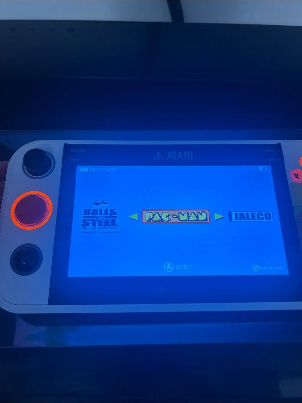 Atari Handheld Gaming Console in White and Orange